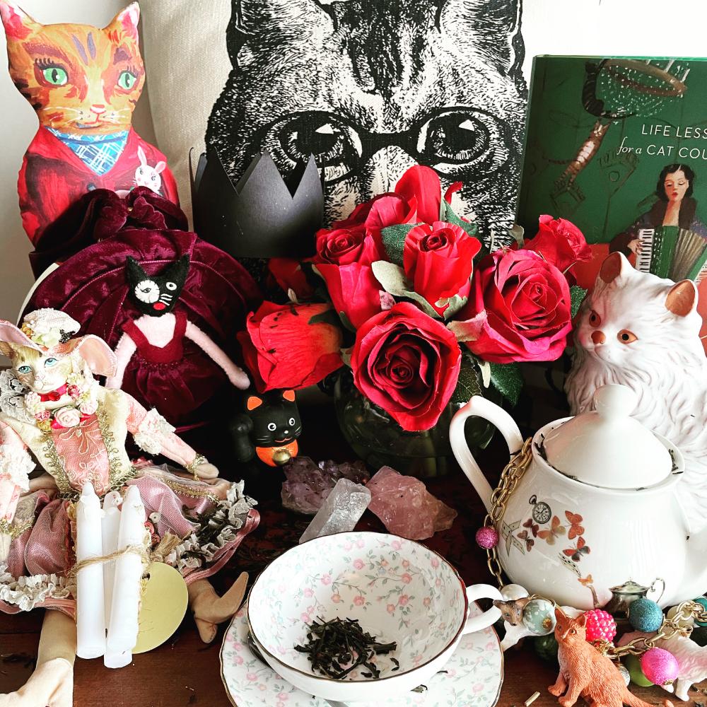 various nicknacks, cat, flowers, teacup