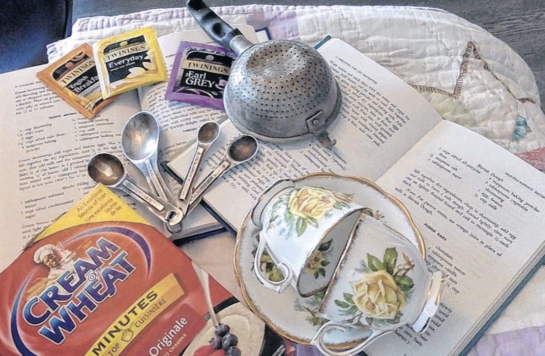 Cream of wheat, tea cups, book, measuring spoons and tea